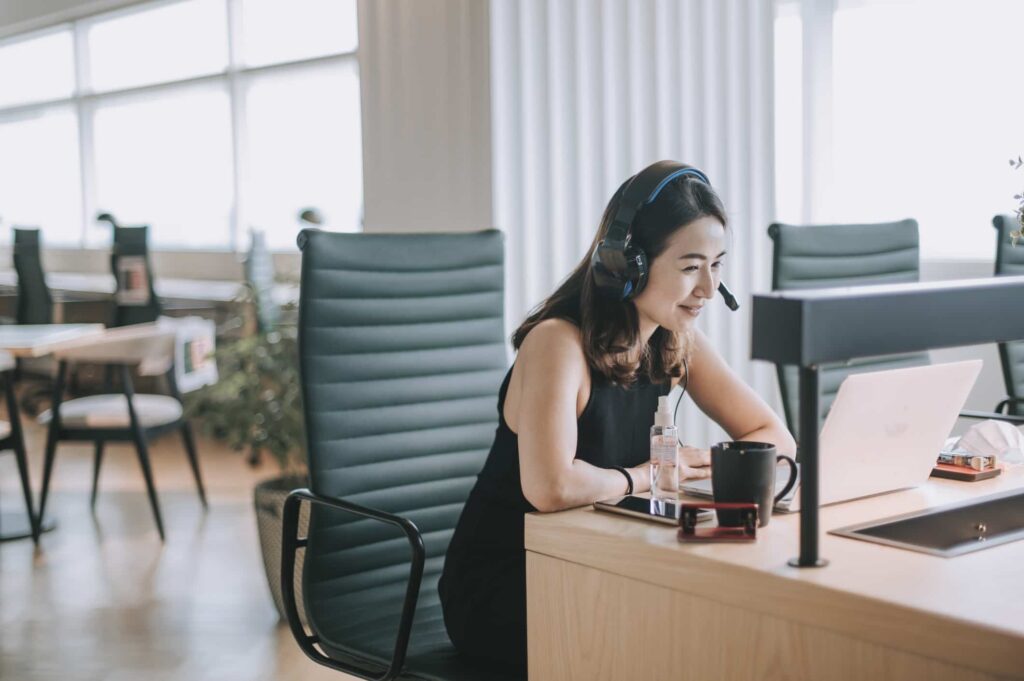 asian woman speaking on the phone using voip systems